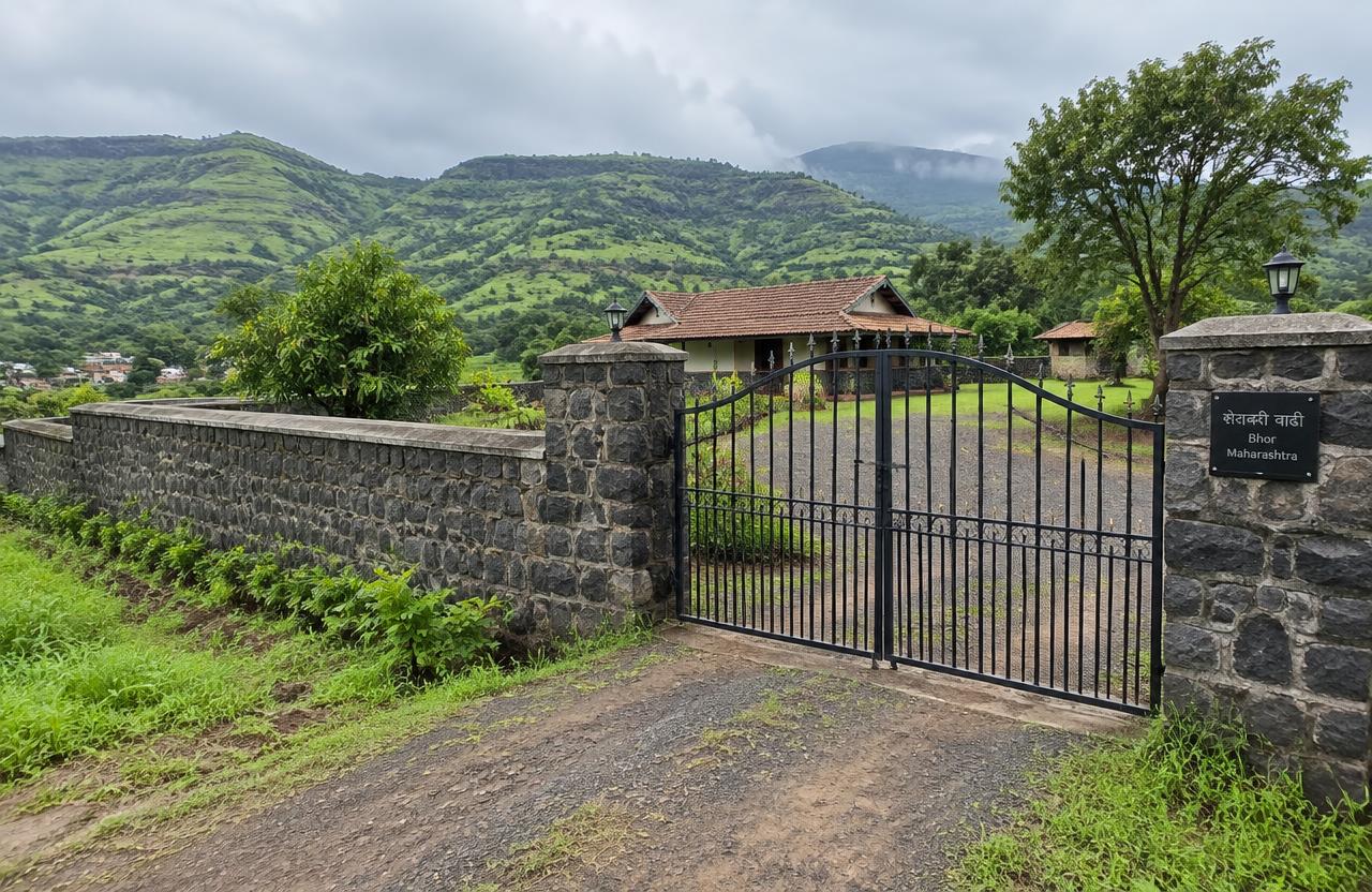 Basalt stone compound wall and gate around a farmhouse in Bhor